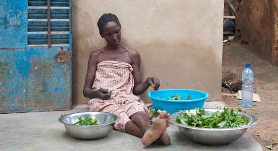 African woman preparing vegetables